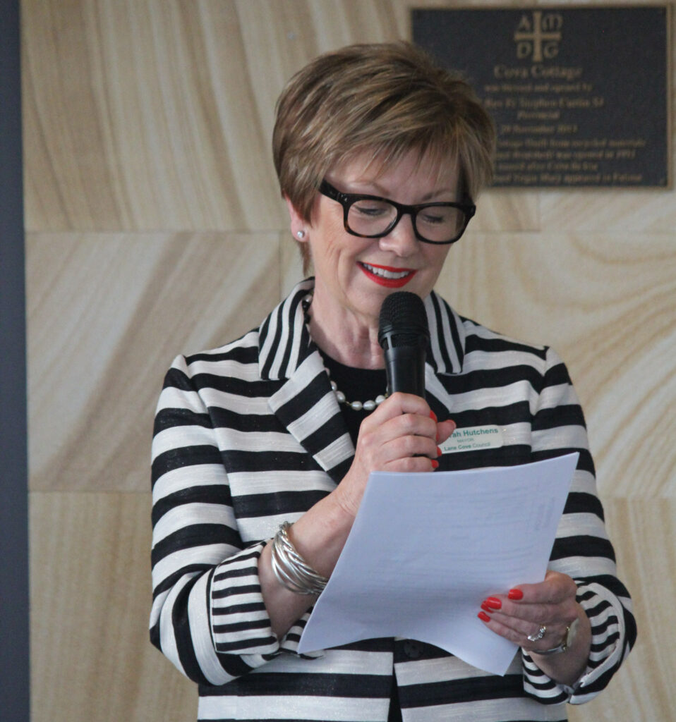 woman holding microphone reading a speech medium close