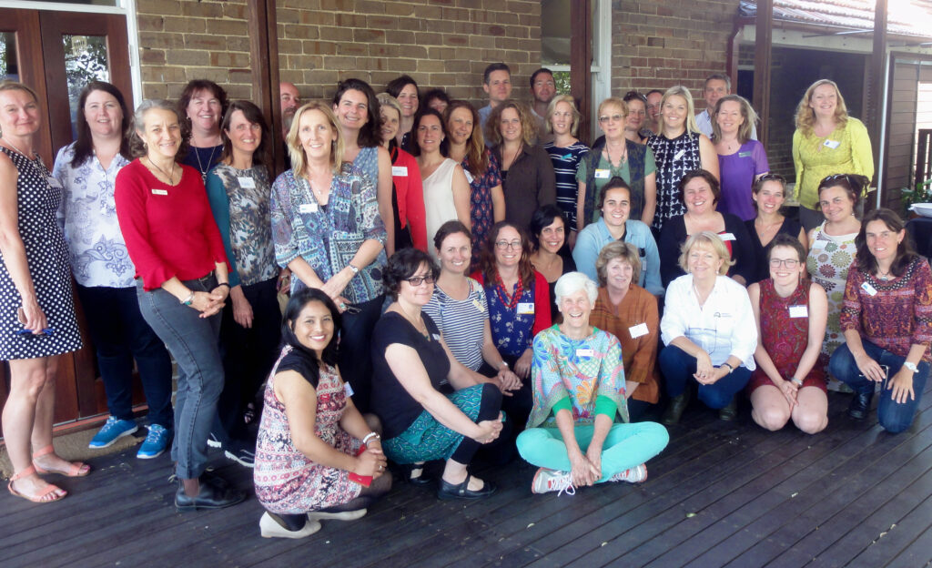 large group photo participants in a workshop indoors